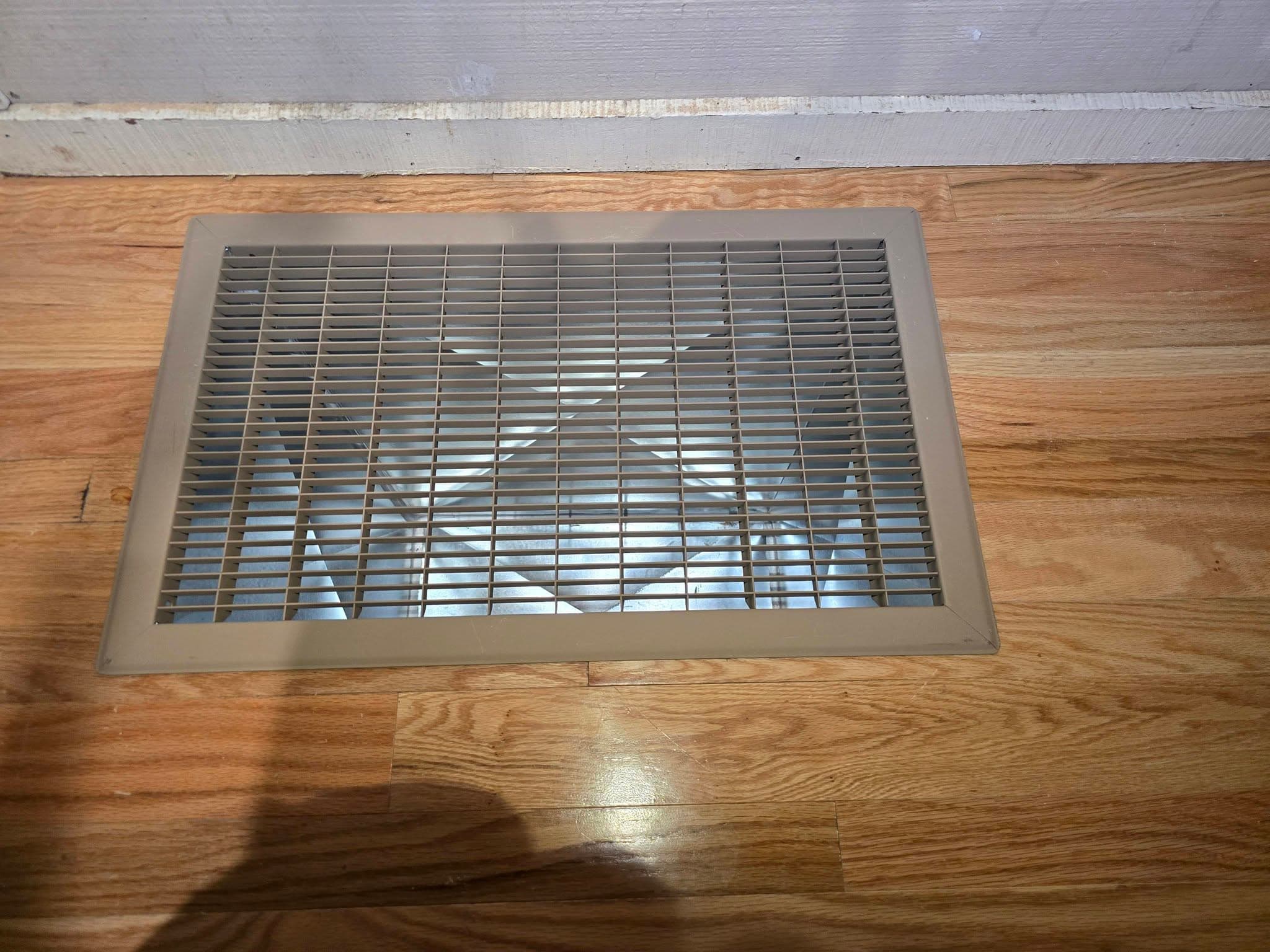 New filter grille / floor register fitted into hardwood